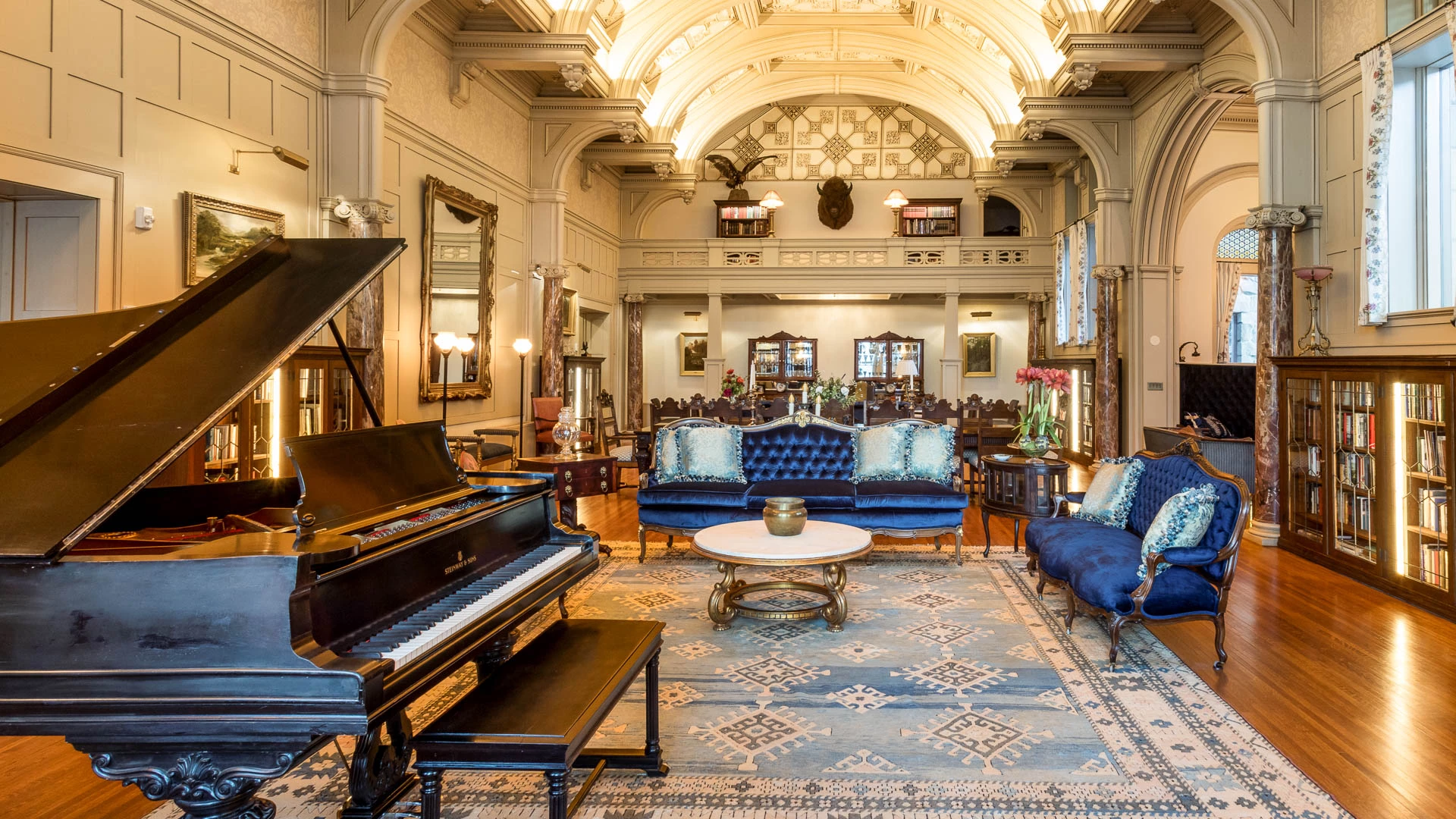 a room with a piano and couches