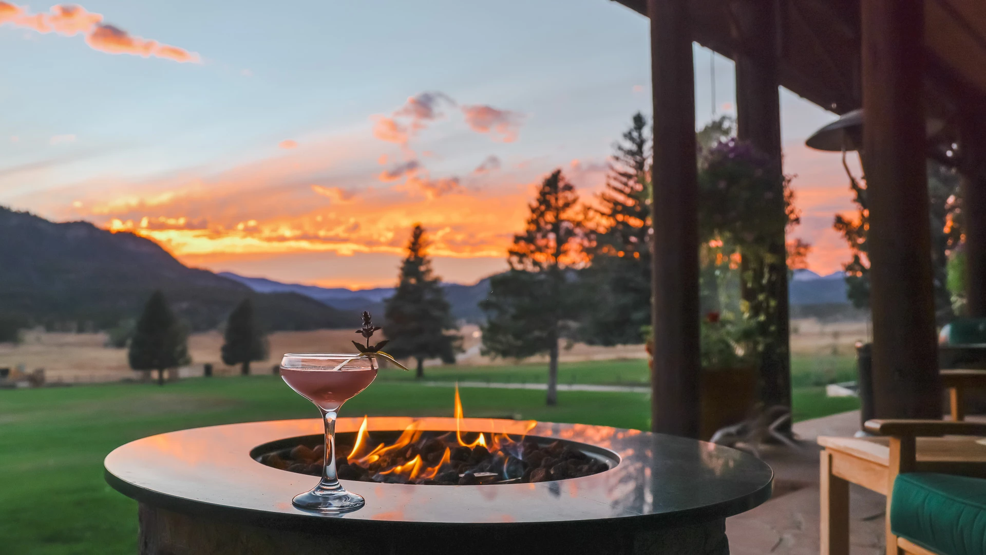 a glass of drink on a fire pit