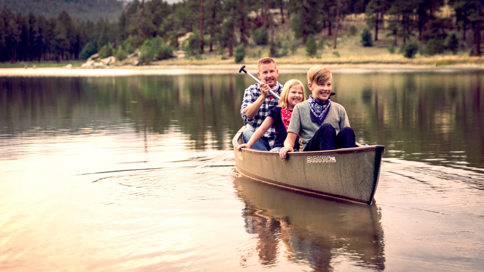 a group of people in a canoe on a lake