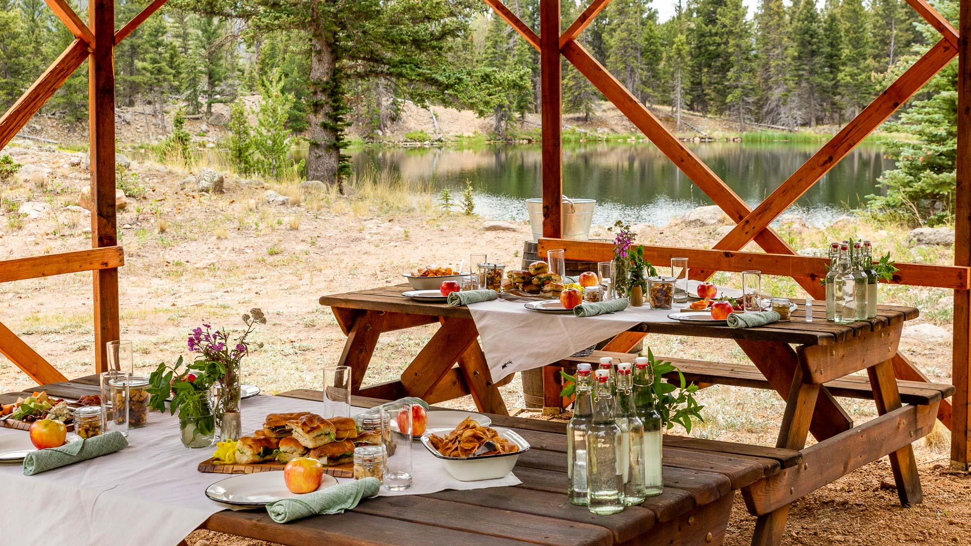 a picnic table with food and drinks on it