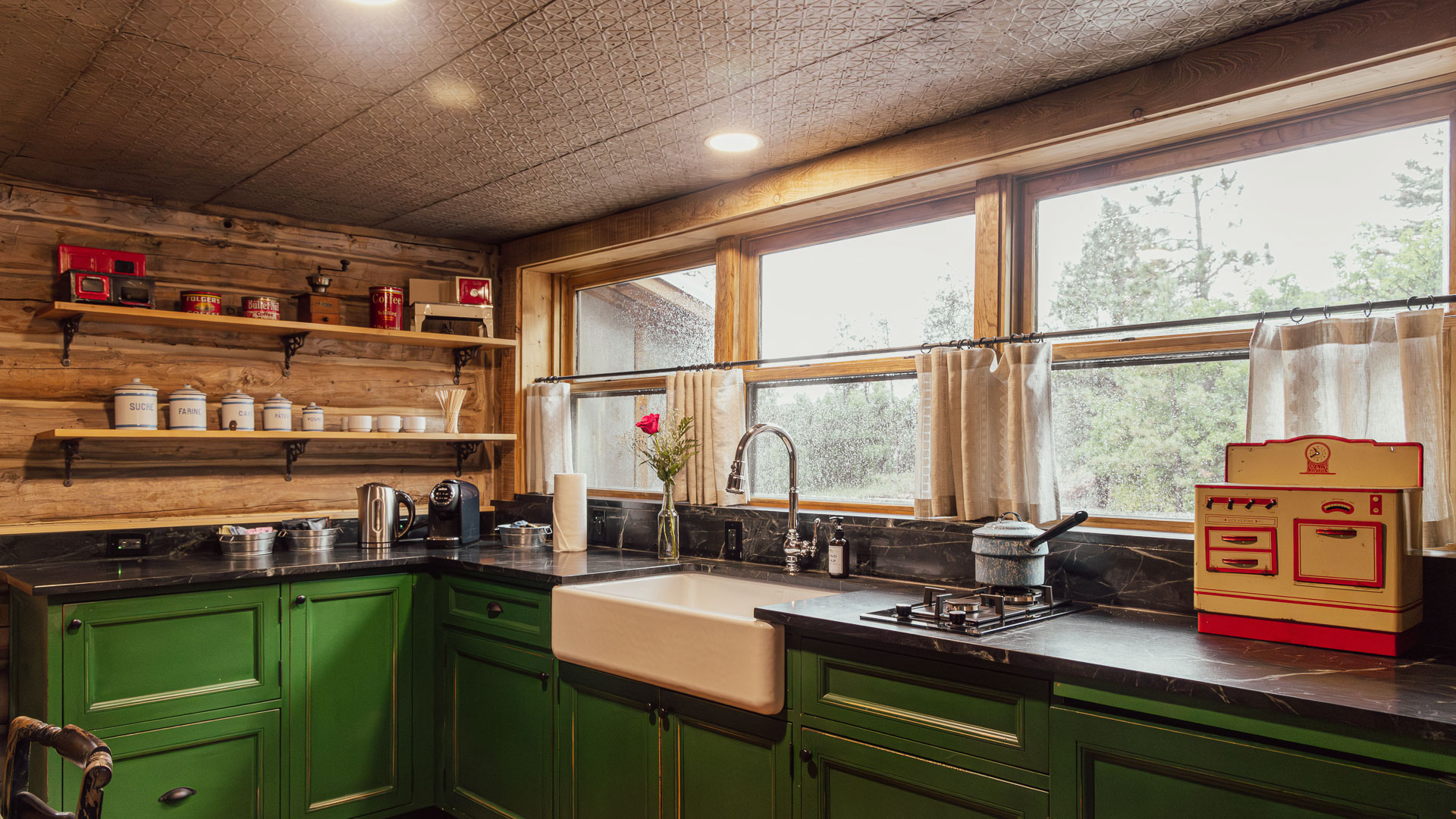 a kitchen with green cabinets and a sink