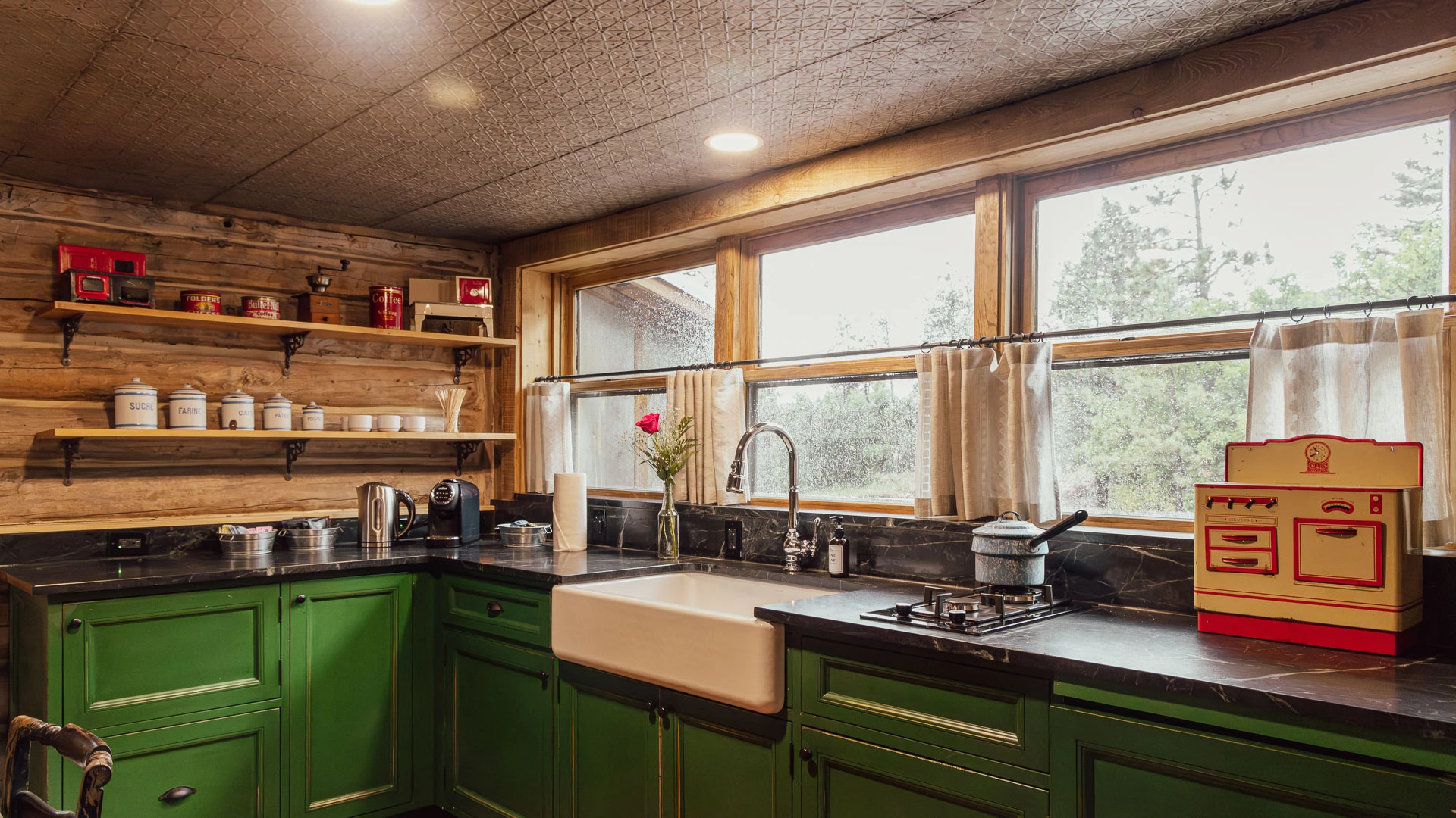 a kitchen with green cabinets and a sink