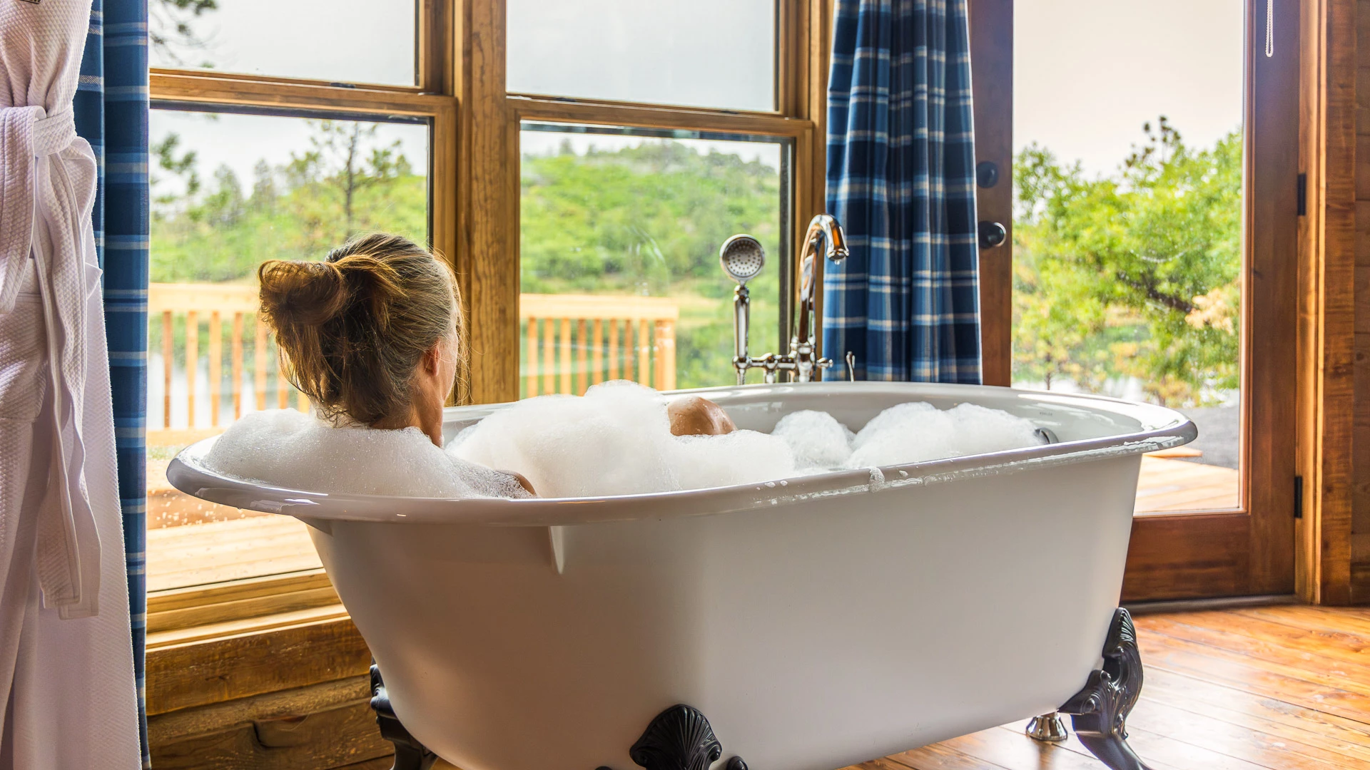 a woman in a bathtub with bubbles