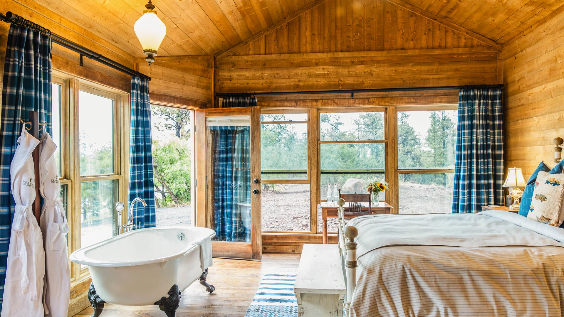 a bedroom with a bathtub and a window