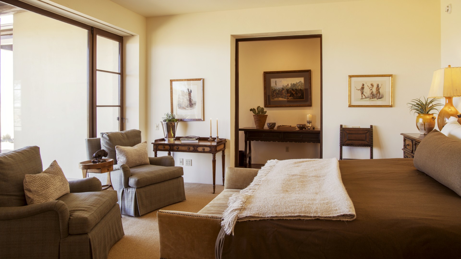 a bedroom with a bed and chairs