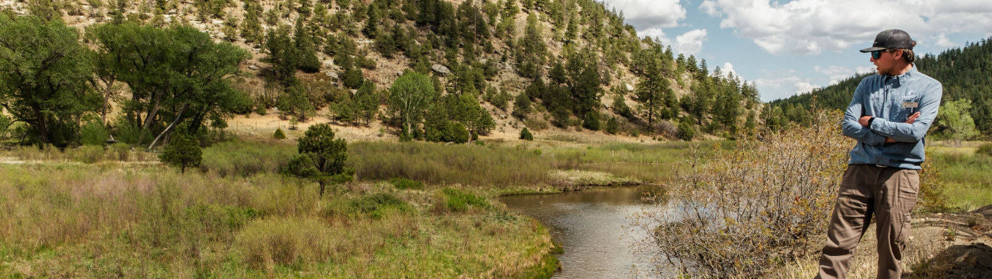 a river next to a hill