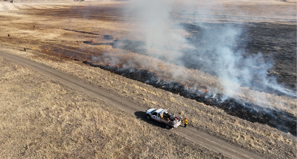 a truck on a dirt road with smoke coming out of it