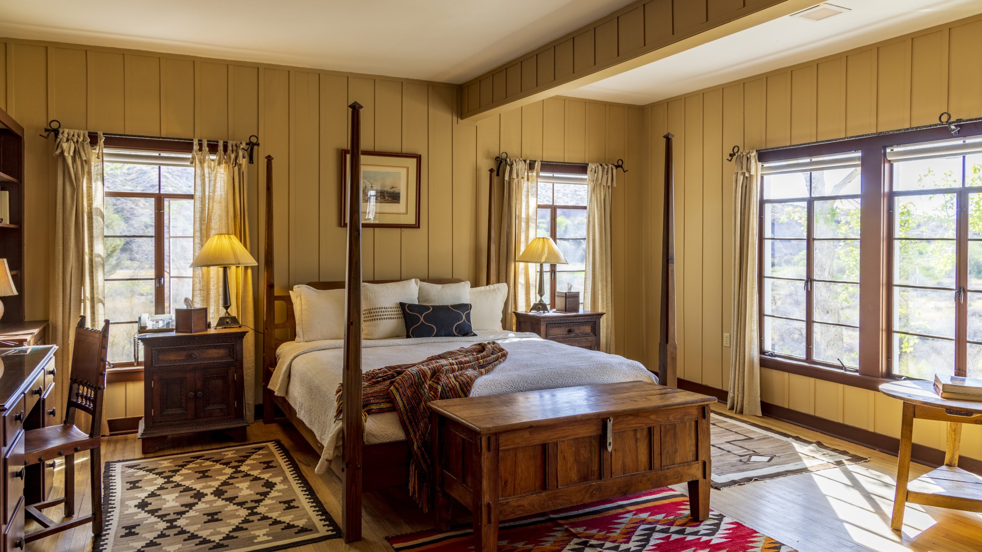 a bedroom with a four poster bed and a rug