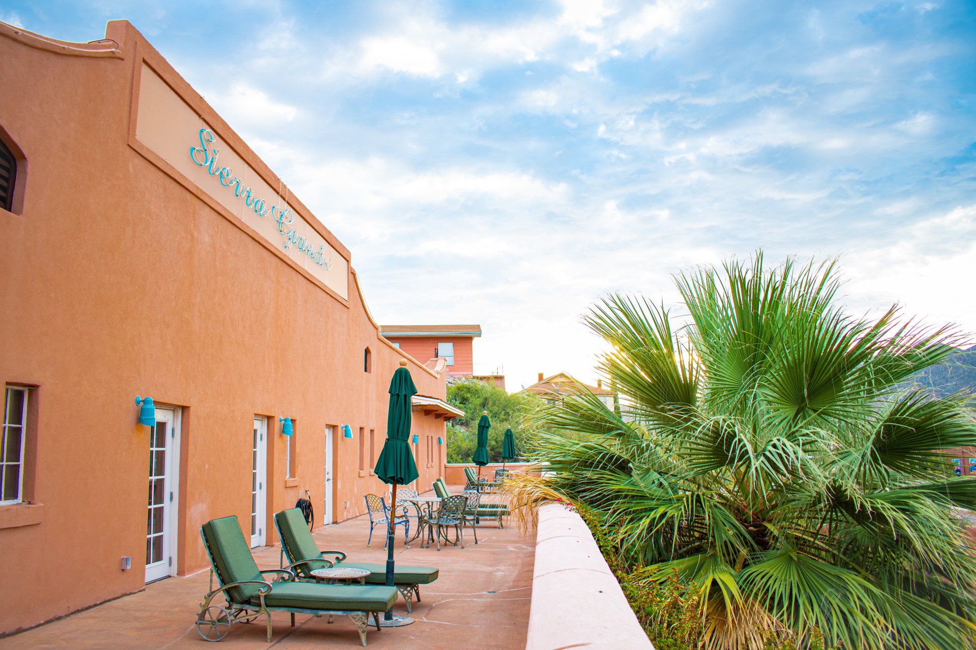 a patio with chairs and umbrellas