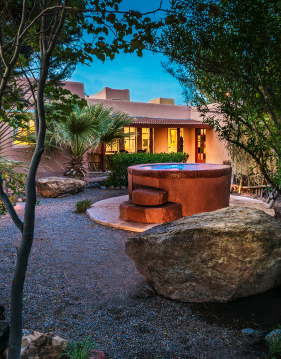 a stone fountain in front of a house