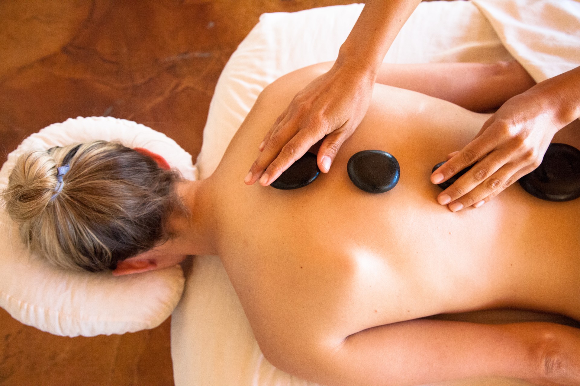 a person receiving a hot stone massage