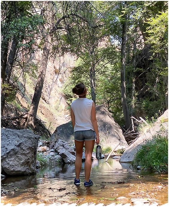 a woman standing in a stream