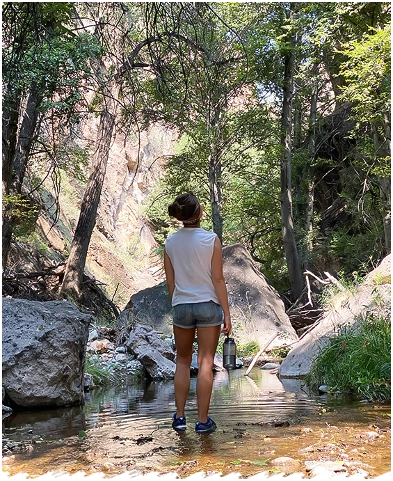 a woman standing in a stream