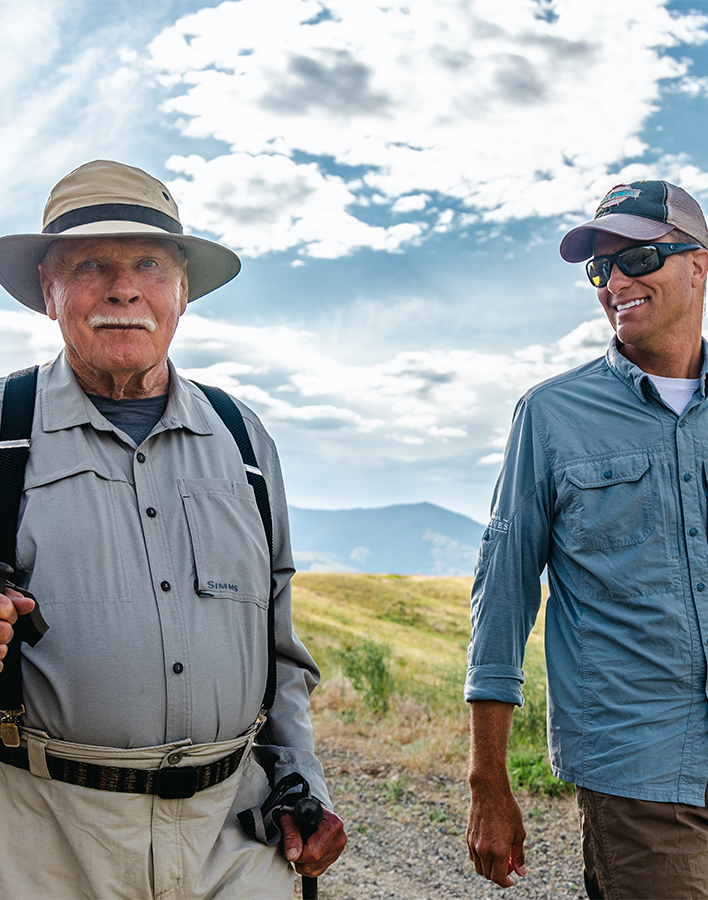 two men standing in a field