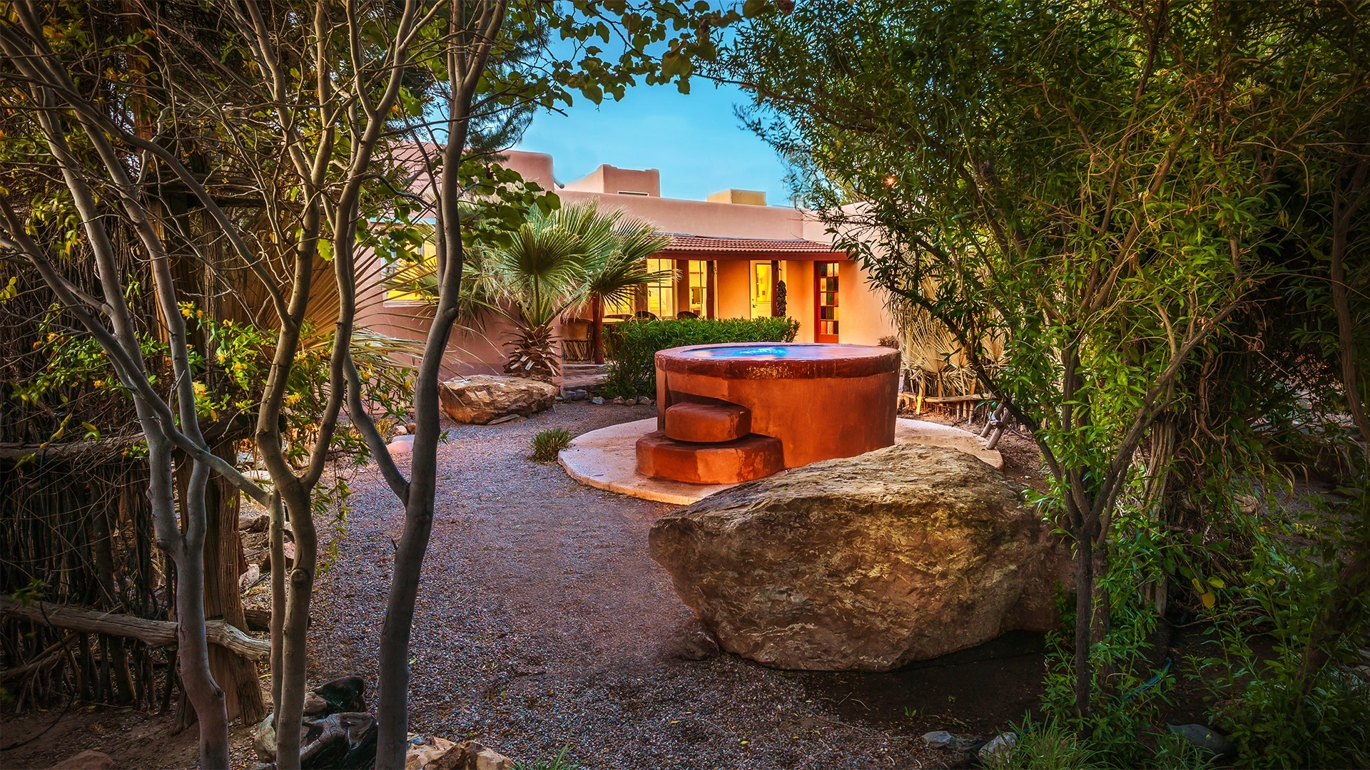 a stone hot tub in a courtyard