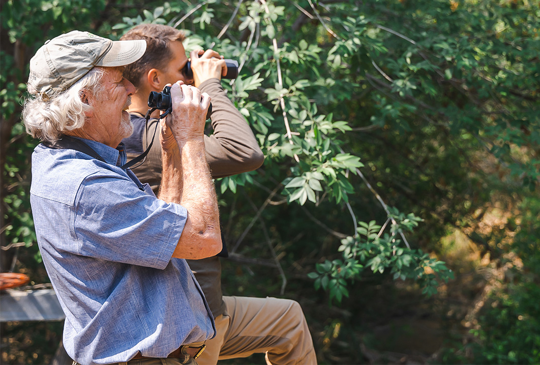 a man and a man looking through binoculars