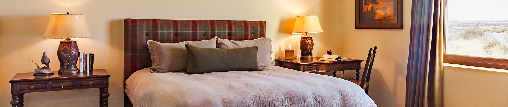 a bed with a lamp on the side table