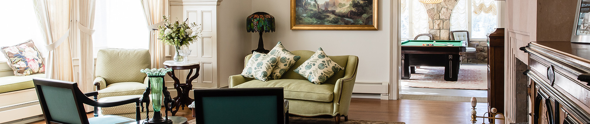 a couch with pillows and a lamp in a room