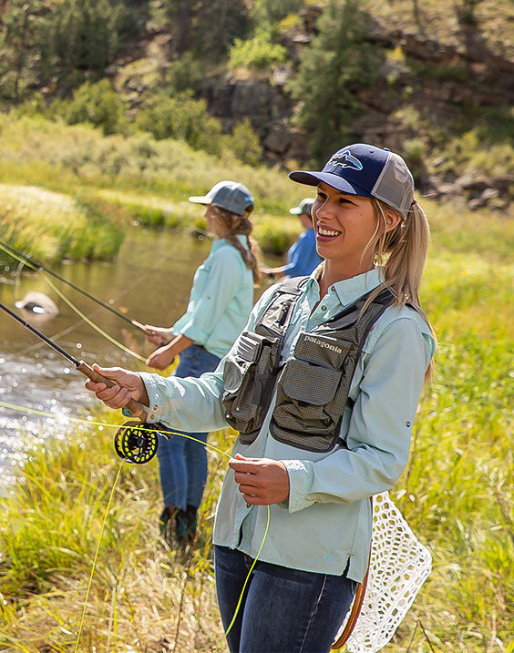 a woman holding fishing poles and smiling
