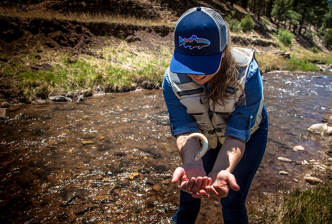 a woman holding a fish in her hand