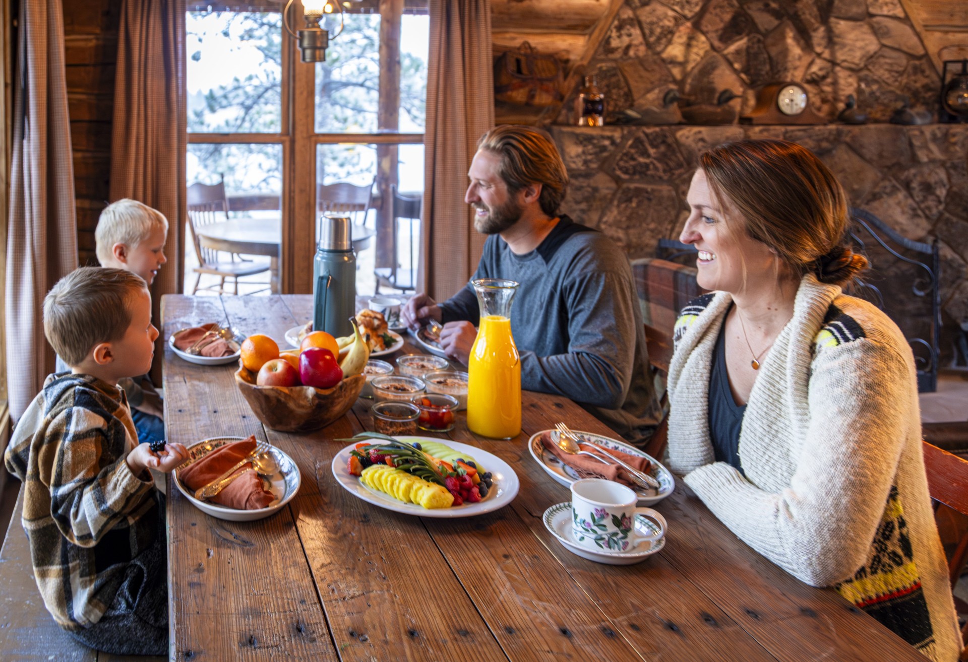 a group of people sitting at a table with food