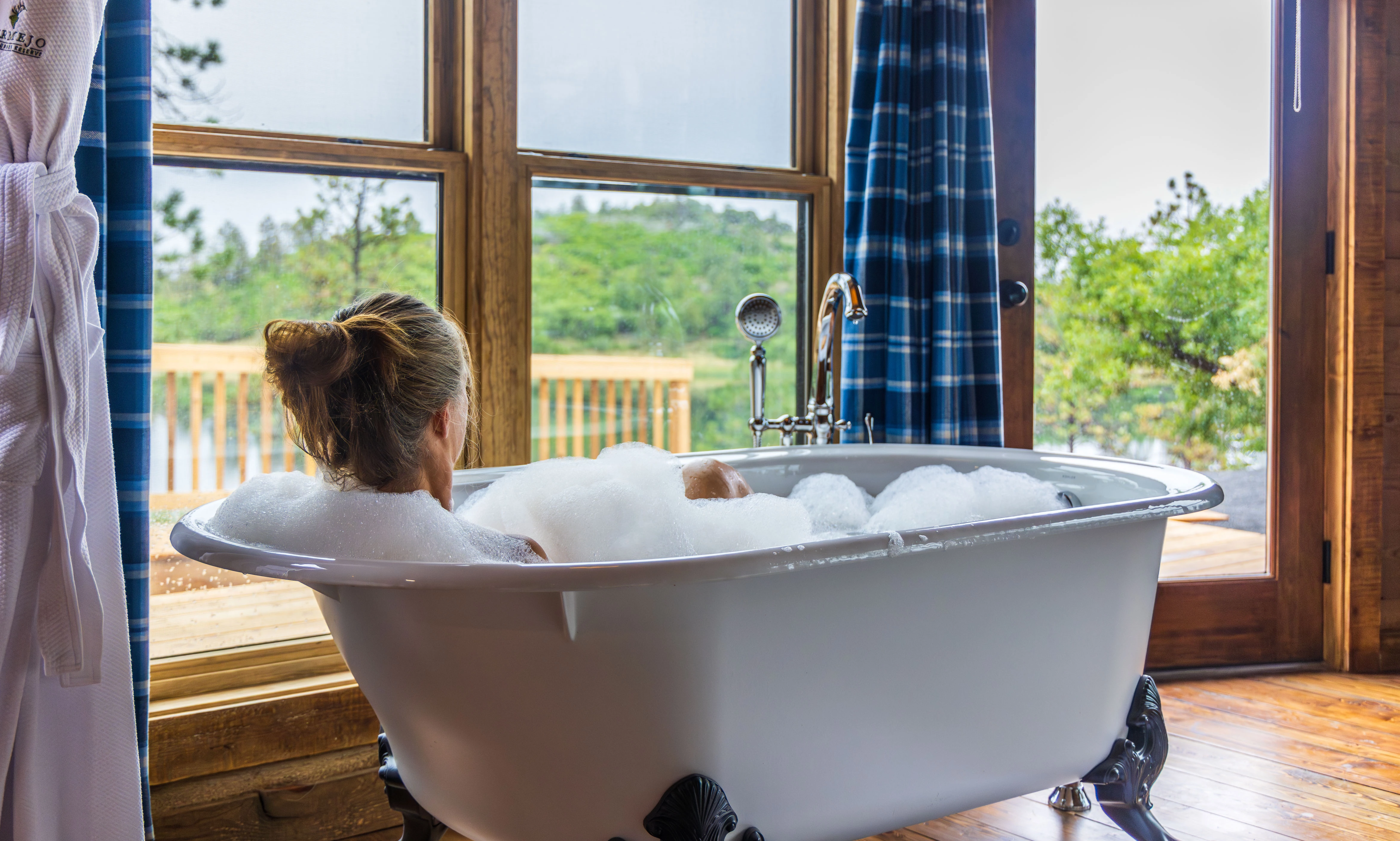 a woman in a bathtub with bubbles
