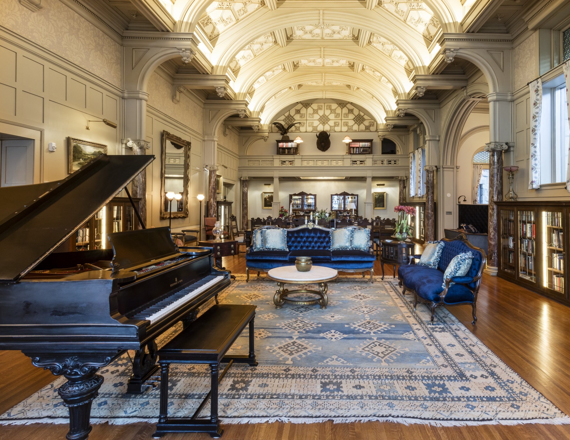 a room with a piano and couches