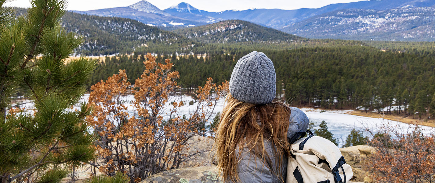 a woman looking at a landscape