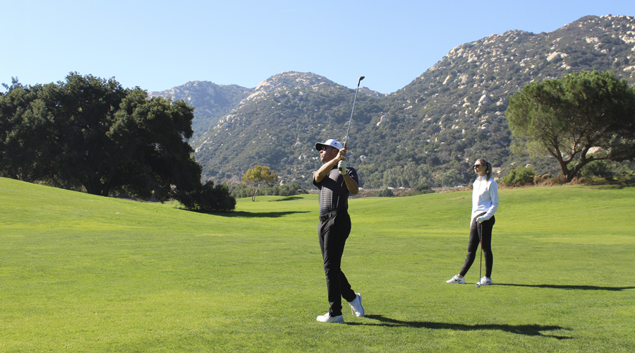 a man and woman on a golf course