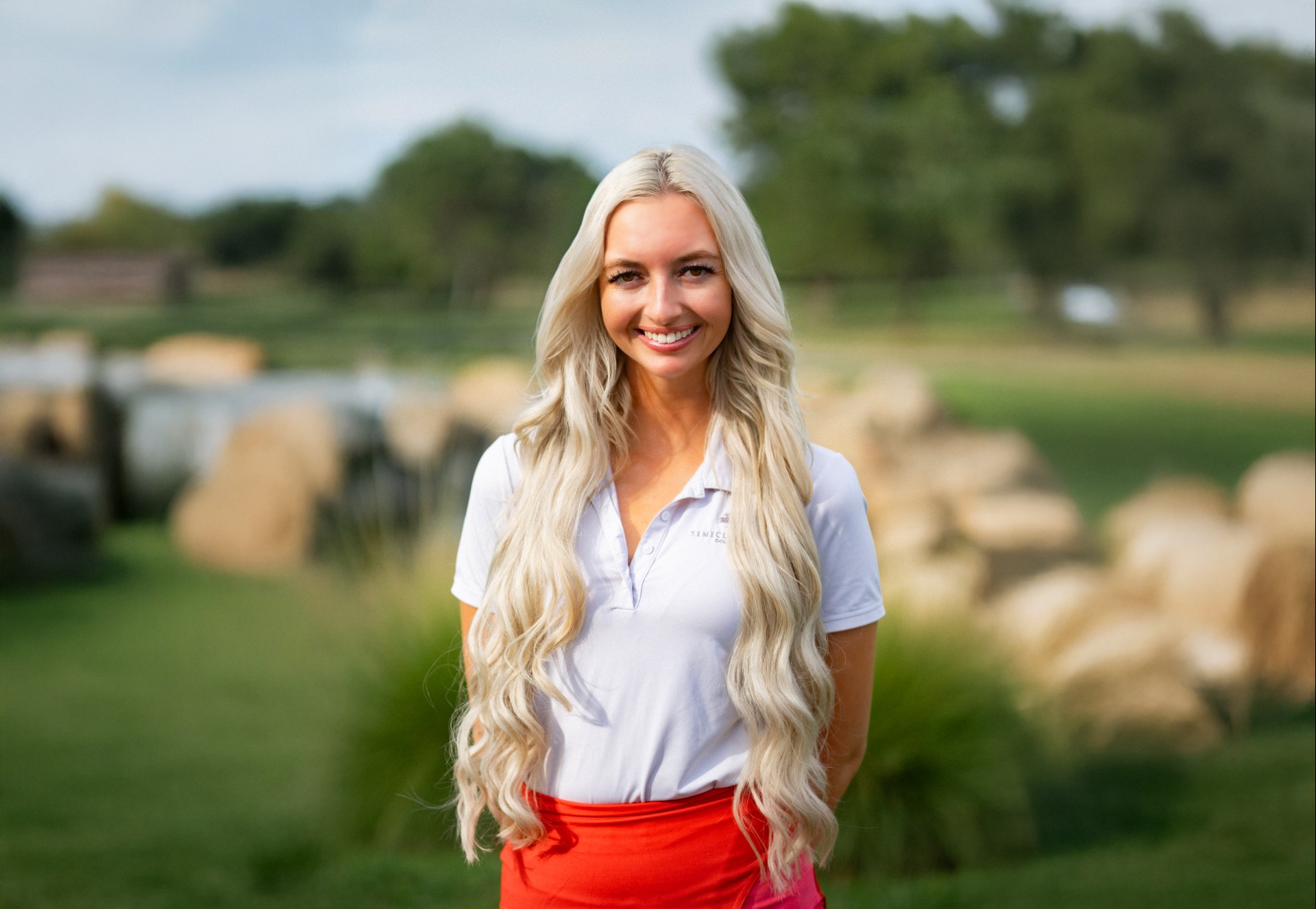 a woman with long blonde hair smiling
