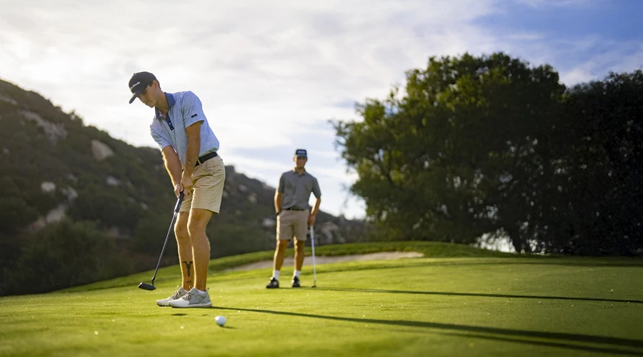 a man playing golf on a golf course