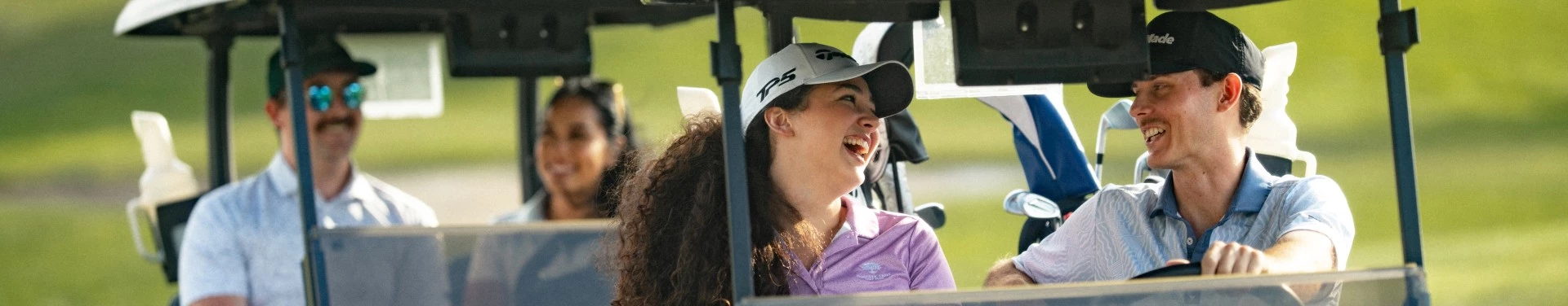 a woman in a golf cart laughing