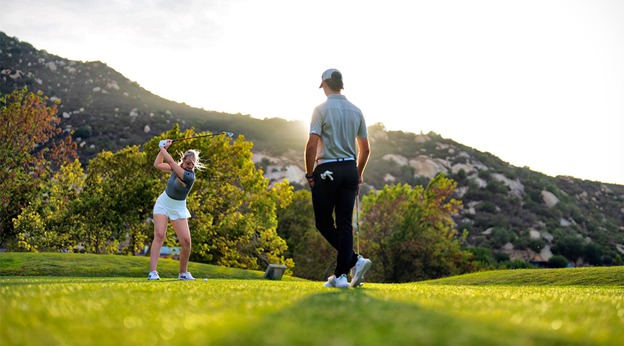 a man and woman playing golf