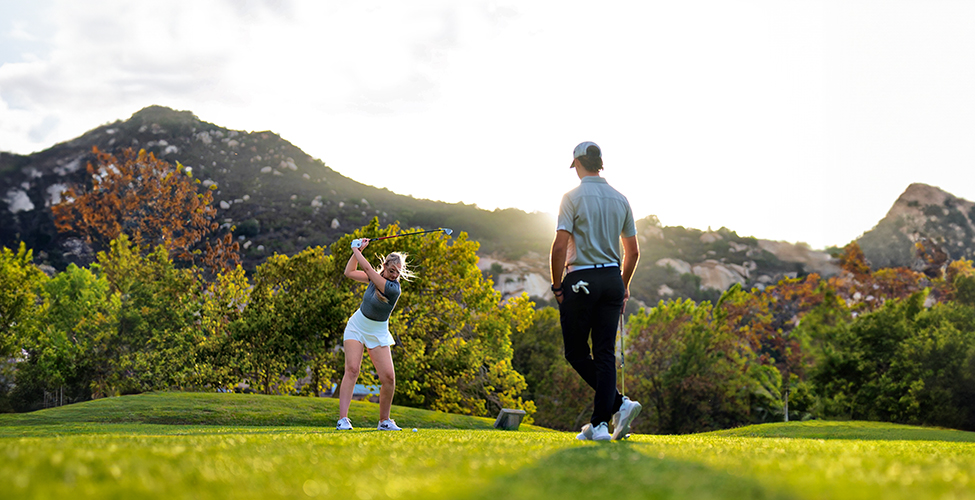 a man and woman playing golf