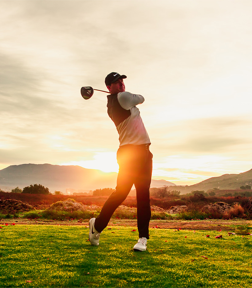 a man swinging a golf club
