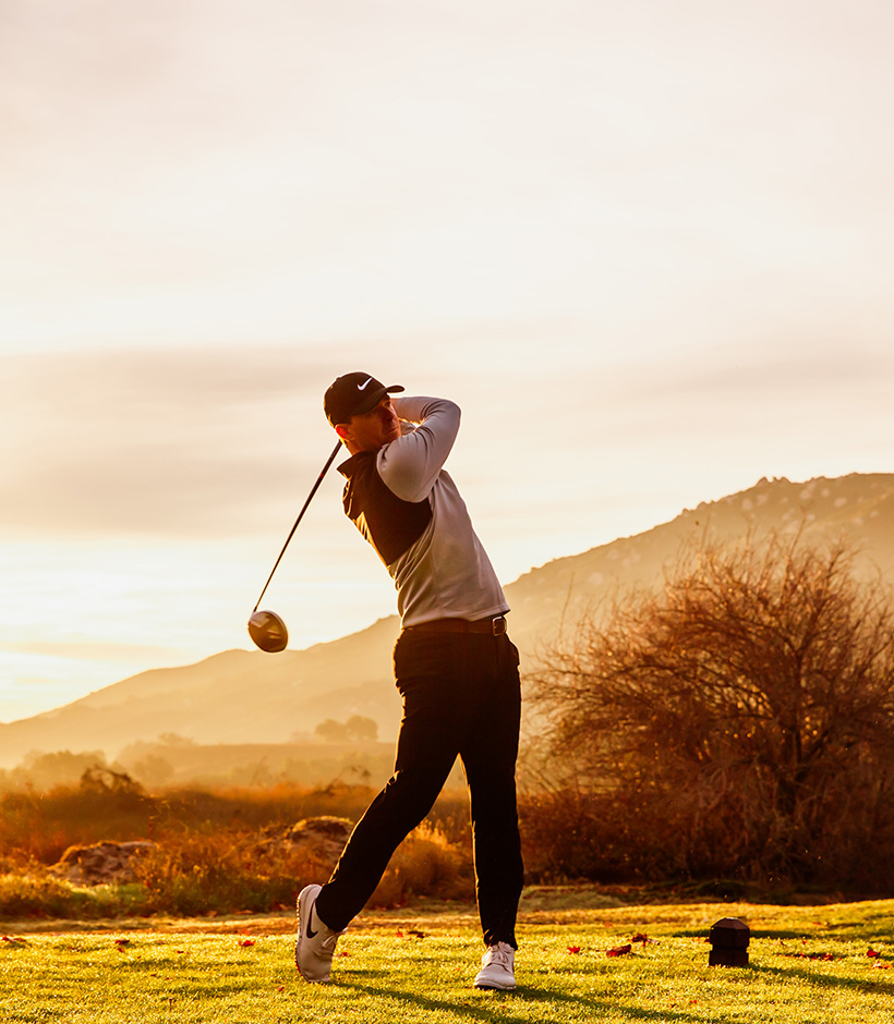 a man swinging a golf club