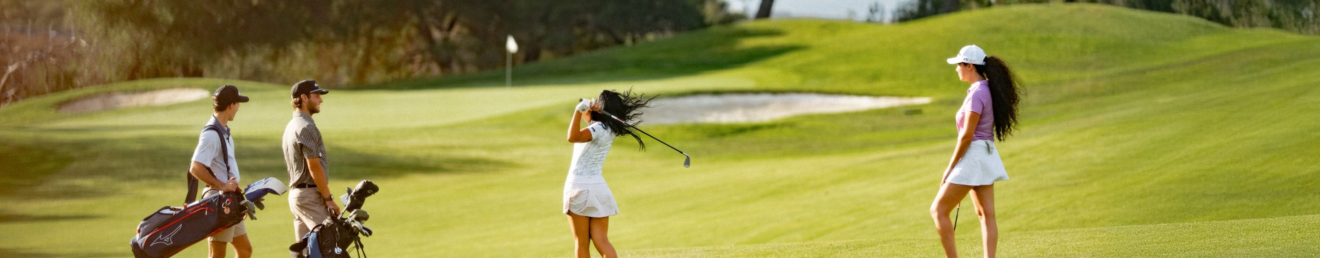 a woman swinging a golf club