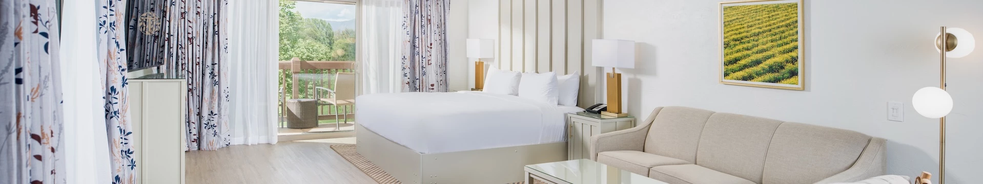 a bed with white sheets and a lamp