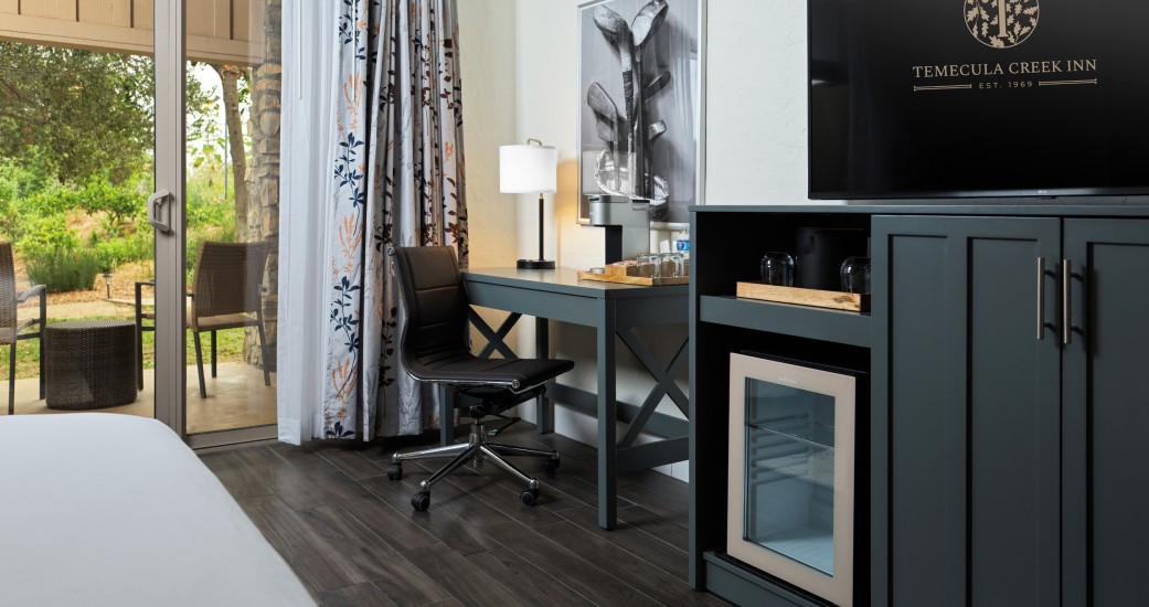 a room with a tv and a desk