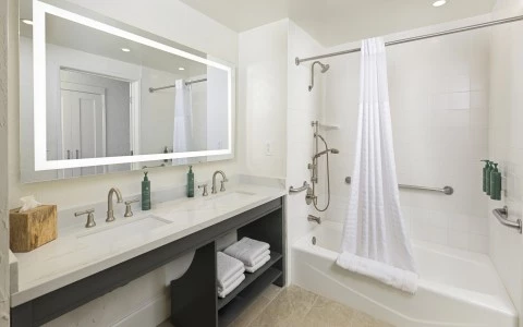 a bathroom with a white shower and a white bathtub