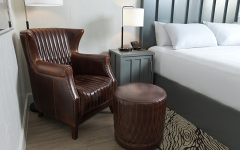 a chair next to a bed