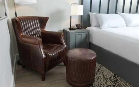 a chair next to a bed
