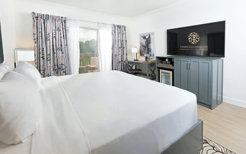 a room with a bed and a television