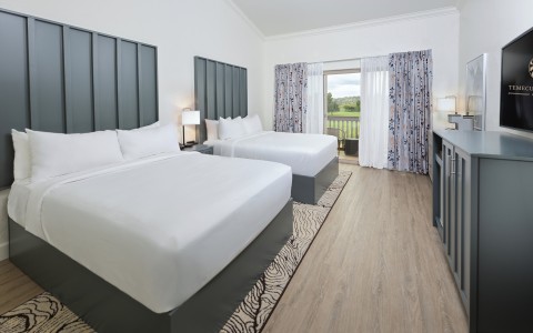 a room with two beds and a table