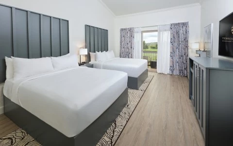 a room with two beds and a table