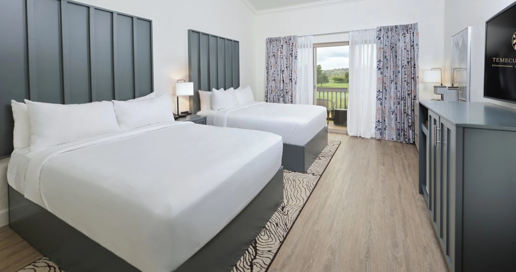 a room with two beds and a table