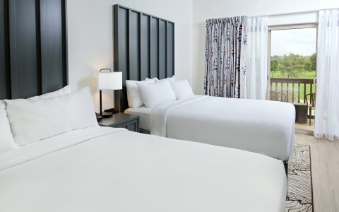 a room with two beds and a window