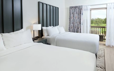 a room with two beds and a window