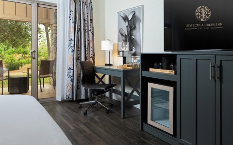 a room with a tv and a desk
