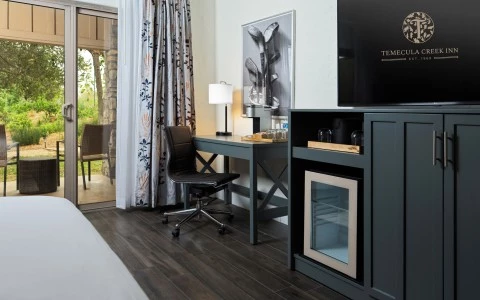 a room with a tv and a desk